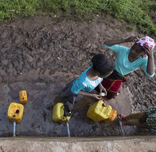 Girls Collecting Water